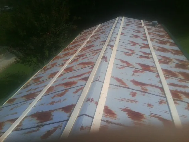 Rusted metal roof panels with new wood purlins before replacement — Storm Damage Roof Repair in Leonardsville by Roofing Brothers